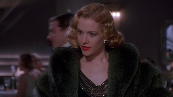 Movie still from “The Shadow” (1994), directed by Russell Mulcahy – A person wearing a fur coat; Close Up shot, Over the shoulder angle