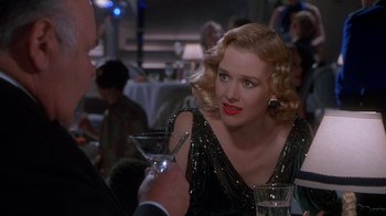 Movie still from “The Shadow” (1994), directed by Russell Mulcahy – A man and a woman sitting at a table with a drink; Close Up shot, Over the shoulder angle