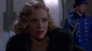 Movie still from “The Shadow” (1994), directed by Russell Mulcahy – A person wearing a fur coat; Close Up shot, Over the shoulder angle