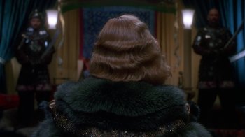 Movie still from “The Shadow” (1994), directed by Russell Mulcahy – The back of a woman's head with long brown hair; Close Up shot, Over the shoulder angle