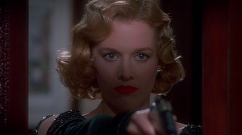 Movie still from “The Shadow” (1994), directed by Russell Mulcahy – A person holding a gun; Close Up shot, Low angle