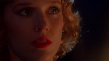 Movie still from “The Shadow” (1994), directed by Russell Mulcahy – A woman's face with red lipstick; Extreme Close Up shot, Over the shoulder angle