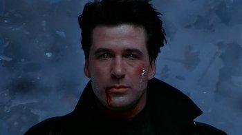 Movie still from “The Shadow” (1994), directed by Russell Mulcahy – A person with blood on his face; Close Up shot, Low angle