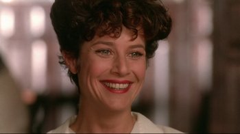 Movie still from “The Sheltering Sky” (1990), directed by Bernardo Bertolucci – A person with a smile on their face; Close Up shot, Low angle