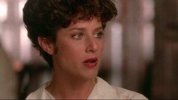 Movie still from “The Sheltering Sky” (1990), directed by Bernardo Bertolucci – A person wearing a white shirt; Close Up shot, Over the shoulder angle