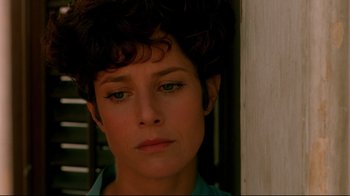 Movie still from “The Sheltering Sky” (1990), directed by Bernardo Bertolucci – A woman's face in front of a wall; Close Up shot, Low angle