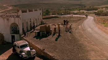 Movie still from “The Sheltering Sky” (1990), directed by Bernardo Bertolucci – An aerial view of an outdoor area with people and bicycles; Extreme Wide shot, High angle