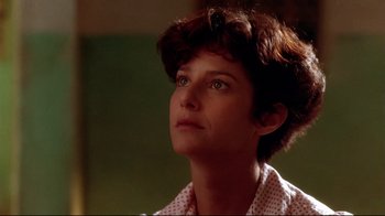 Movie still from “The Sheltering Sky” (1990), directed by Bernardo Bertolucci – A person with short hair looking up; Close Up shot, Low angle