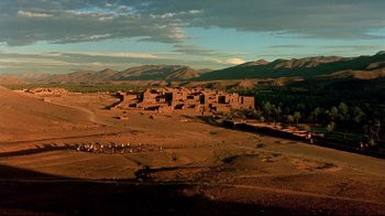 Movie still from “The Sheltering Sky” (1990), directed by Bernardo Bertolucci – An aerial view of an old village in the desert; Extreme Wide shot, High angle
