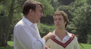 Movie still from “The Shout” (1978), directed by Jerzy Skolimowski – Two men talking to each other in a field; Medium shot, Over the shoulder angle