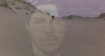 Movie still from “The Shout” (1978), directed by Jerzy Skolimowski – A double exposure of a man with a beard; Wide shot, High angle