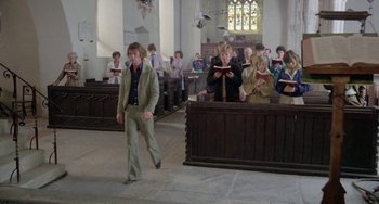 Movie still from “The Shout” (1978), directed by Jerzy Skolimowski – A group of people sitting in a room; Wide shot, High angle