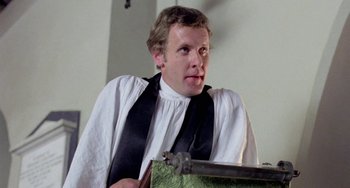 Movie still from “The Shout” (1978), directed by Jerzy Skolimowski – A man wearing a white shirt and a black tie; Close Up shot, Low angle