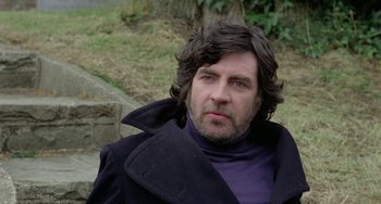 Movie still from “The Shout” (1978), directed by Jerzy Skolimowski – A person wearing a jacket; Close Up shot, Low angle