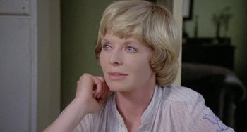 Movie still from “The Shout” (1978), directed by Jerzy Skolimowski – A person with short blonde hair; Close Up shot, Low angle