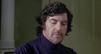 Movie still from “The Shout” (1978), directed by Jerzy Skolimowski – A person wearing a sweater; Close Up shot, Low angle