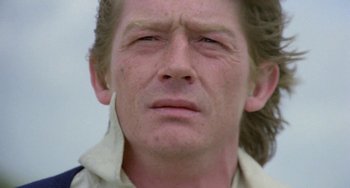 Movie still from “The Shout” (1978), directed by Jerzy Skolimowski – A person with long hair; Close Up shot, Low angle