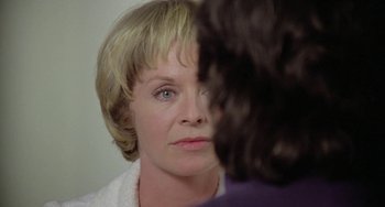 Movie still from “The Shout” (1978), directed by Jerzy Skolimowski – A person looking into a mirror; Close Up shot, Over the shoulder angle