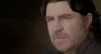 Movie still from “The Shout” (1978), directed by Jerzy Skolimowski – A person with a beard; Close Up shot, Low angle