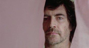 Movie still from “The Shout” (1978), directed by Jerzy Skolimowski – A person with a beard; Close Up shot, Low angle