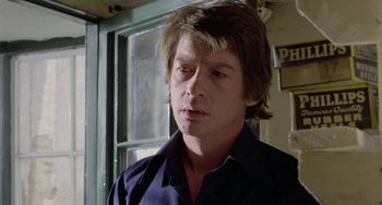 Movie still from “The Shout” (1978), directed by Jerzy Skolimowski – A person with long hair; Close Up shot, Over the shoulder angle