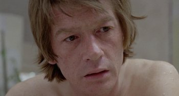 Movie still from “The Shout” (1978), directed by Jerzy Skolimowski – A man's face in a room; Close Up shot, Low angle