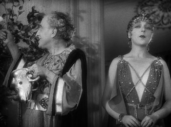 Movie still from “The Sign of the Cross” (1932), directed by Cecil B. DeMille – A man and a woman dressed up in costumes; Medium shot, Low angle