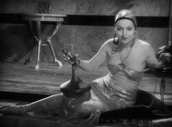 Movie still from “The Sign of the Cross” (1932), directed by Cecil B. DeMille – A woman sitting on the ground with a vase in her hand; Medium shot, High angle