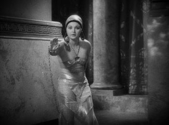 Movie still from “The Sign of the Cross” (1932), directed by Cecil B. DeMille – A black and white photo of a woman holding a chain; Medium shot, High angle