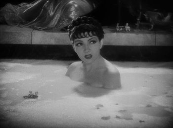 Movie still from “The Sign of the Cross” (1932), directed by Cecil B. DeMille – A black - and - white photo of a woman in a bath tub; Close Up shot, High angle