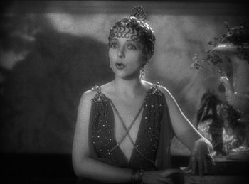 Movie still from “The Sign of the Cross” (1932), directed by Cecil B. DeMille – An old photo of a woman wearing a dress; Close Up shot, Low angle