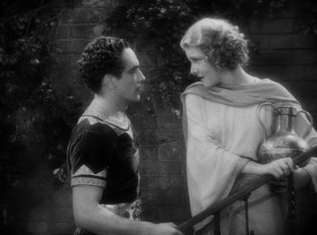 Movie still from “The Sign of the Cross” (1932), directed by Cecil B. DeMille – A man and a woman standing next to a railing; Medium shot, High angle