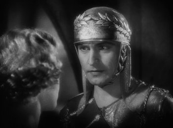 Movie still from “The Sign of the Cross” (1932), directed by Cecil B. DeMille – A black and white photo of a man wearing a helmet; Close Up shot, Low angle