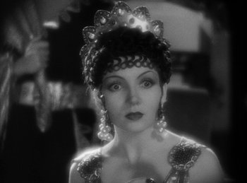 Movie still from “The Sign of the Cross” (1932), directed by Cecil B. DeMille – A black - and - white photo of a woman wearing a tiara; Close Up shot, Over the shoulder angle