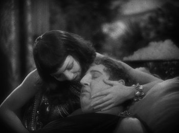 Movie still from “The Sign of the Cross” (1932), directed by Cecil B. DeMille – A man and a woman embracing each other in a black and white photo; Close Up shot, High angle