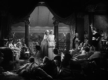 Movie still from “The Sign of the Cross” (1932), directed by Cecil B. DeMille – A group of people sitting in a room; Extreme Wide shot, High angle