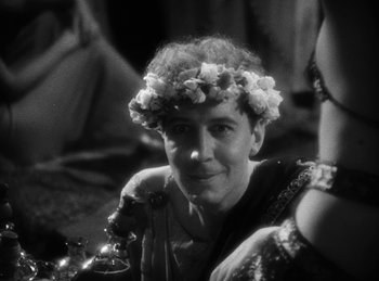 Movie still from “The Sign of the Cross” (1932), directed by Cecil B. DeMille – An old photo of a woman wearing a wreath of flowers; Close Up shot, Over the shoulder angle
