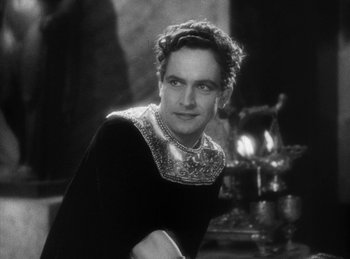 Movie still from “The Sign of the Cross” (1932), directed by Cecil B. DeMille – An old photo of a man in a black dress; Medium shot, Low angle