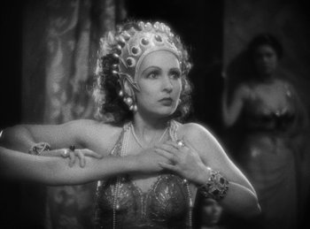 Movie still from “The Sign of the Cross” (1932), directed by Cecil B. DeMille – A black and white photo of a woman in a costume; Close Up shot, Over the shoulder angle