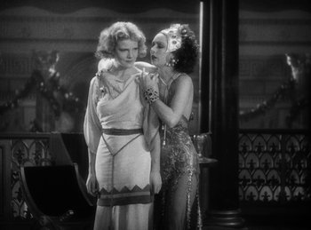 Movie still from “The Sign of the Cross” (1932), directed by Cecil B. DeMille – A couple of women standing next to each other; Medium shot, Over the shoulder angle