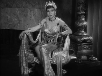 Movie still from “The Sign of the Cross” (1932), directed by Cecil B. DeMille – A woman sitting on a chair wearing a costume; Medium shot, High angle
