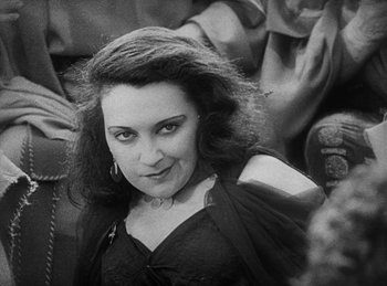 Movie still from “The Sign of the Cross” (1932), directed by Cecil B. DeMille – Black and white photograph of a woman smiling for the camera; Close Up shot, Low angle