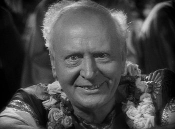 Movie still from “The Sign of the Cross” (1932), directed by Cecil B. DeMille – An older man wearing a flower garland around his neck; Close Up shot, High angle