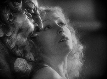 Movie still from “The Sign of the Cross” (1932), directed by Cecil B. DeMille – An old black and white photo of a woman and a dog; Close Up shot, Low angle