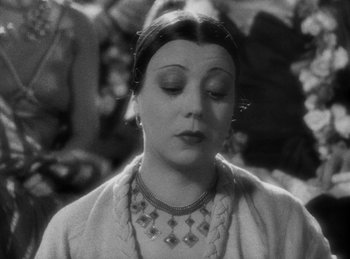 Movie still from “The Sign of the Cross” (1932), directed by Cecil B. DeMille – An old photo of a woman with a necklace; Close Up shot, High angle