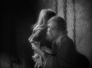 Movie still from “The Sign of the Cross” (1932), directed by Cecil B. DeMille – A man and a woman are holding each other; Medium shot, High angle