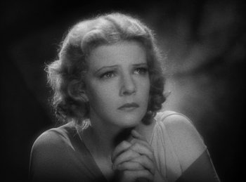 Movie still from “The Sign of the Cross” (1932), directed by Cecil B. DeMille – An old photo of an older woman with her hands clasped together; Close Up shot, Low angle