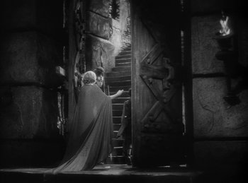 Movie still from “The Sign of the Cross” (1932), directed by Cecil B. DeMille – An old photo of a man in a cloak walking up a staircase; Wide shot, High angle