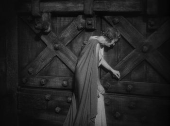 Movie still from “The Sign of the Cross” (1932), directed by Cecil B. DeMille – A woman wearing a long dress and holding a towel; Medium shot, High angle
