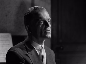 Movie still from “The Silence of the Sea” (1949), directed by Jean-Pierre Melville – An older man wearing a suit and tie; Close Up shot, Low angle